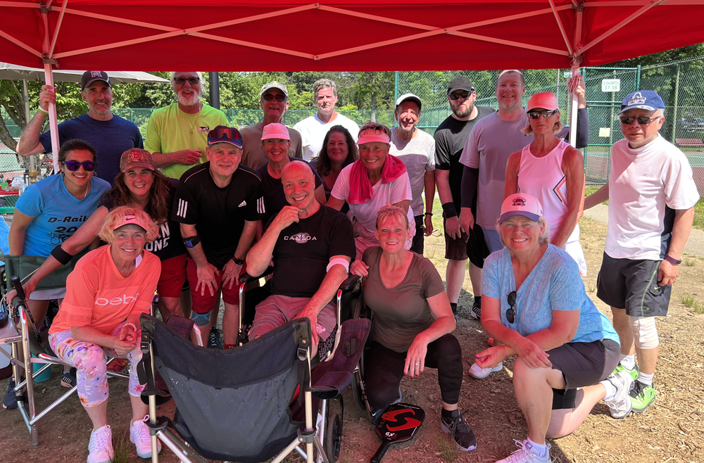 Ronnie Recchia, seated in the center, surrounded by nearly 20 pickleball friends in 2022.